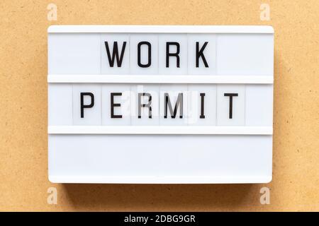Lightbox with word work permit on wood background Stock Photo