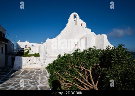 Famous tourist landmark of Greece - Greek Orthodox Church of Panagia Paraportiani in town of Chora on Mykonos island, Greece on sunrise Stock Photo