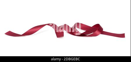 twisted red silk ribbon with bends isolated on white background, festive decor Stock Photo