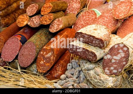 Different types of raw smoked sausage on the store shelf. Stock Photo