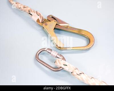 Figure eight knot with carabiner. Silver carabiner with lock andrope isolated on white background. Stock Photo
