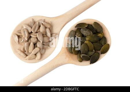 Close-up top view of two wooden spoons filled with sunflower seeds and pumpkin seeds isolated on white. Stock Photo