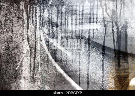 Surface texture with splashes of paint and with paint running down on a metallic surface structure in basic color gray. For abstract backgrounds. Germ Stock Photo