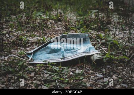 Face mask abandoned on the ground Stock Photo