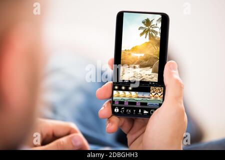 Editing Videos On Mobile Phone Using Video Editor App Stock Photo