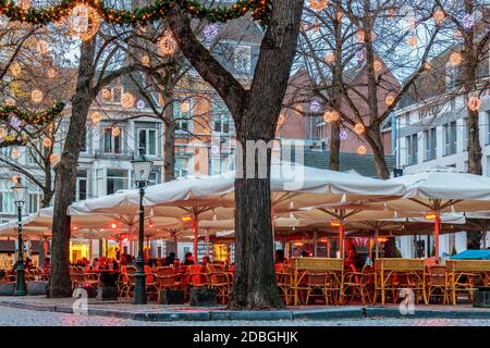 MAASTRICHT, THE NETHERLANDS - NOVEMBER 22, 2016: Dinner tables of bars and restaurants with christmas lights on the famous Onze Lieve Vrouweplein Stock Photo