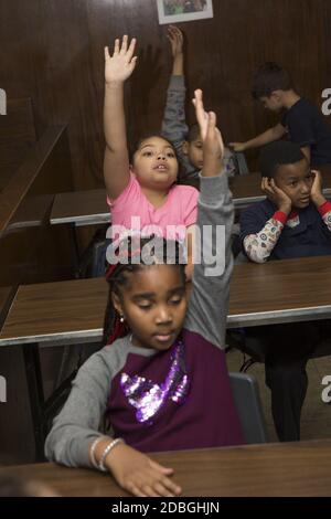 Elementary school children participate in a discussion  at a community center on the Lower East Side of Manhattan, New York City. Stock Photo