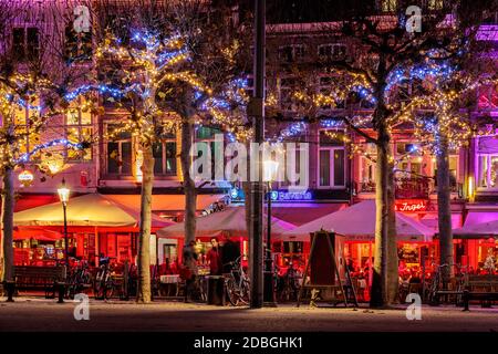 MAASTRICHT, THE NETHERLANDS - NOVEMBER 22, 2016: Bars and restaurants with christmas lights on the famous Vrijthof square in Maastricht, The Netherlan Stock Photo