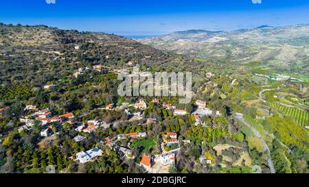 Aerial bird eye view of Miliou village hills and Akamas sea at Latchi, Paphos Cyprus. View of traditional ceramic tile roof houses near Ayii Anargyri Stock Photo