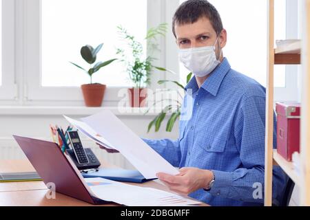a person in an office in the workplace is studying the data in the documents Stock Photo