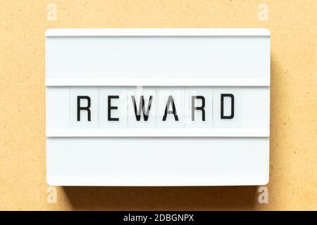 Lightbox with word reward on wood background Stock Photo