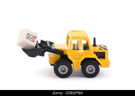 Bulldozer with new email graphic on computer key isolated on white background with clipping path Stock Photo
