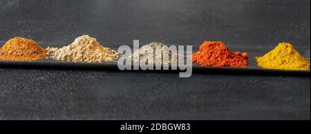 Different kinds of spices on black background Stock Photo
