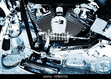 part of the neat motorcycle with cylinder and a lot of chrome in blue monochrome Stock Photo