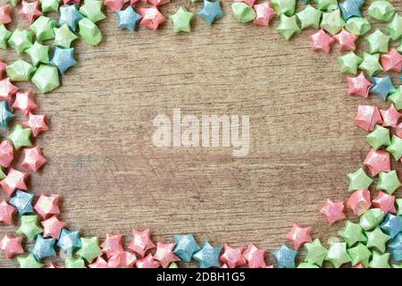 colorful star paper spreading from plastic straw on table Stock Photo