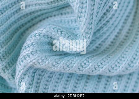 Background of woolen knitted light green blue warm sweater top view. Cloth sample concept Stock Photo