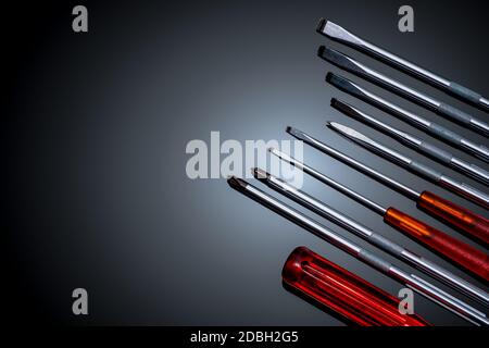 Screwdriver and center punch. Mechanic hand tools. Screwdriver sets with interchangeable blades. Mobile tools set. Tools set on black background. Scre Stock Photo