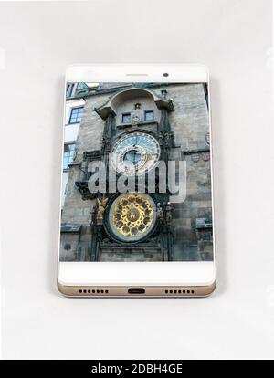 Modern smartphone with full screen picture of the iconic Prague Astronomical Clock, Czech Republic. Concept for travel smartphone photography. All ima Stock Photo
