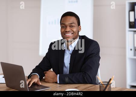 Happy african american businessman looking at camera Stock Photo