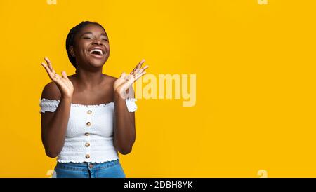 Portrait Of Happy Black Laughing Woman Spreading Hands With Excitement Stock Photo