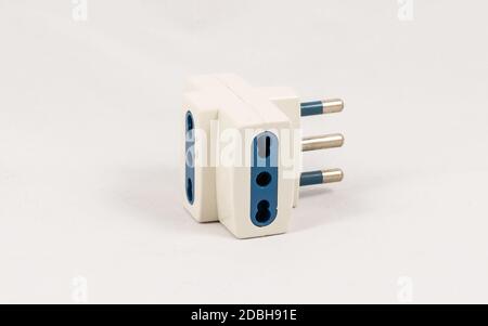Three way EU electric plug adaptor, isolated on white background Stock Photo