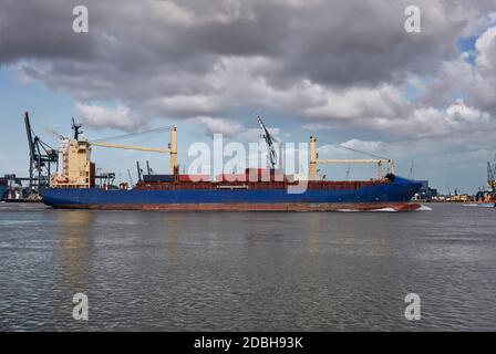 Panoramic image of a container ship passing cranes in Rotterdam harbor. The Netherlands Stock Photo