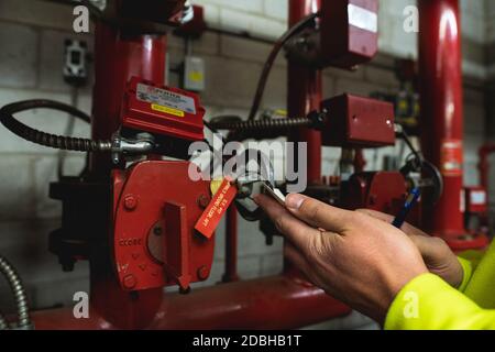 Unrecognizable Technician hand inspecting sprinkler system card Stock Photo