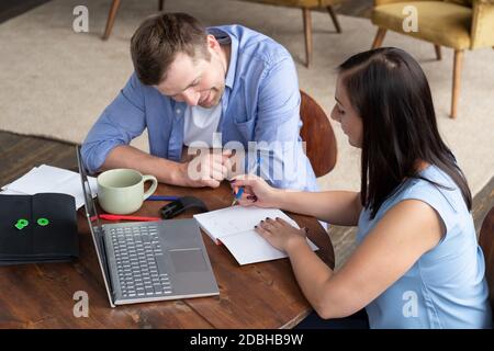 Businesswoman explaining something to her coworker in an office Stock Photo