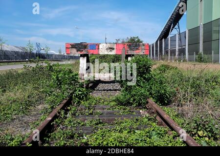 wooden buffer stop with red stop sign ending rail tracks concept for limit. Buffer stop . The final line Stock Photo
