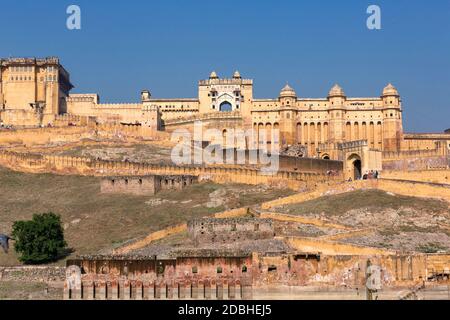 Amber Fort illuminated by warm light of the rising sun. Famous Indian landmark located nearby Jaipur city in Rajasthan, India Stock Photo