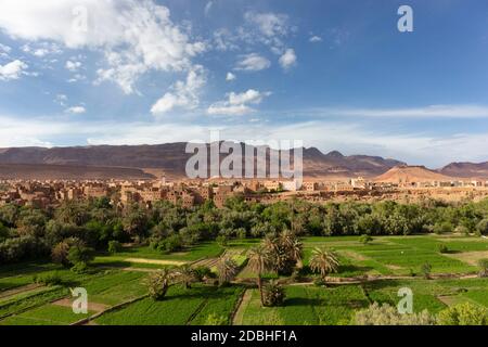 The ancient moroccan town near Tinghir with old kasbahs and high Atlas mountains in background, Tinghir, Morocco in Africa Stock Photo