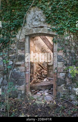 Abandoned country house, door with fallen interior (Lazio, Italy, Europe) Stock Photo