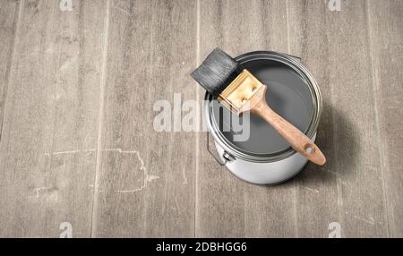 House renovation, paint can with Grey paint on the old wooden background with copy space Stock Photo