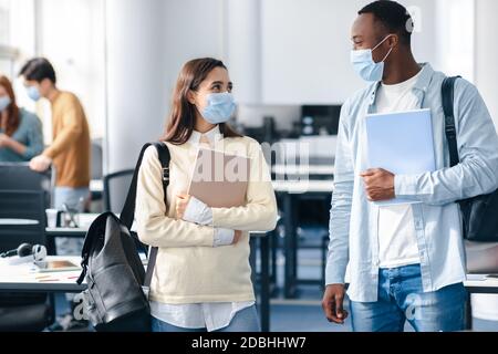 International students wearing medical masks and talking Stock Photo
