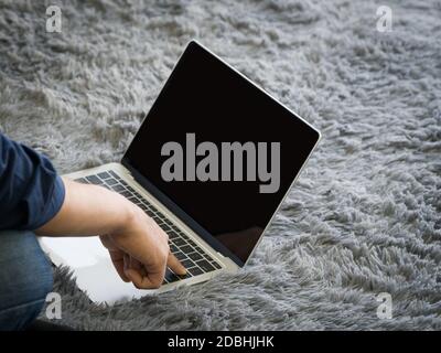 Young man use his finger press enter key on keyboard to waking computer from sleep mode. Stock Photo