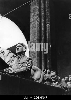 Adolf Hitler in front of the Feldherrnhalle during a speech on Munich's Odeonsplatz. Behind him is Hermann Goering. Stock Photo