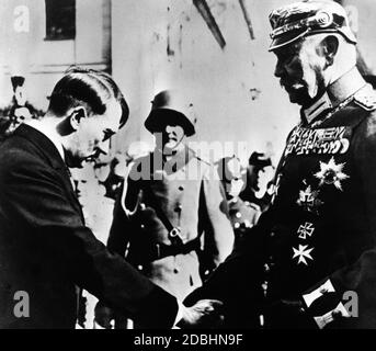 The new Reich Chancellor Adolf Hitler bows before Reich President Paul von Hindenburg when shaking hands. Hitler greets the Field Marshal upon his arrival in front of the Garnisonskirche in Potsdam. The New York Times photographer Theo Eisenhart's photo only acquired its iconic significance after 1945. Stock Photo