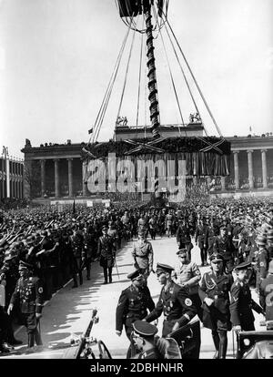 'Adolf Hitler leaves the Berlin Lustgarten after his speech. Further ahead is Martin Bormann. The SS can be recognized by their armband as belonging to the Leibtstandarte ''Adolf Hitler''. On the left side of the picture is their commander Sepp Dietrich.' Stock Photo