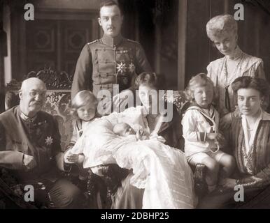 Duke Ernst August III of Brunswick (center) with his family on the occasion of the baptism of their third child. From left to right: Duke Ernst August II of Hanover, Prince Georg Wilhelm of Hanover, Hereditary Prince Ernst August IV of Hanover, Ernst August III of Brunswick and Hanover (in the field uniform of a hussar with the St. George Order of Hanover and an Iron Cross), the christened child Princess Frederica Louisa of Hanover (later Queen of Greece), the mother Duchess Victoria Louise of Hanover (born of Prussia, Hereditary Prince Ernst August IV of Hanover, Duchess Thyra of Hanover