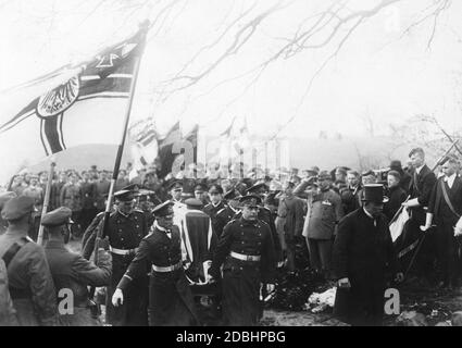 The funeral of Prince Henry of Prussia took place on April 24, 1929. He was buried in a mausoleum on his estate Hemmelmark. In the picture some naval officers carry the coffin into the mausoleum. Around them stand and salute other officers and mourners. Stock Photo