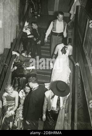 'On February 10, 1933, the Verein fuer Deutsches Kunstgewerbe in Berlin organized an artist's masquerade ball called ''Die bunte Laterne'' in the  Festraeumen des Zoo. The photograph shows couples sitting on a staircase.' Stock Photo