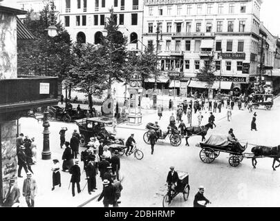 'The photograph shows the intersection of Friedrichstrasse and Unter den Linden in Berlin in 1913, filled with carts and passers-by, with numerous billboards hanging from the houses, including one that is in the middle of the street: ''Julius Staudt. Photograph'', ''Ludwig Fischer'' and ''Krueger & Oberbeck'' (tobacco shop).' Stock Photo