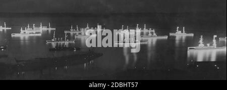 Warships of the Royal Navy gather festively illuminated for a rehearsal for the fleet review planned for the coronation celebrations of King George V on June 22, 1911 in the port of Portsmouth. Stock Photo