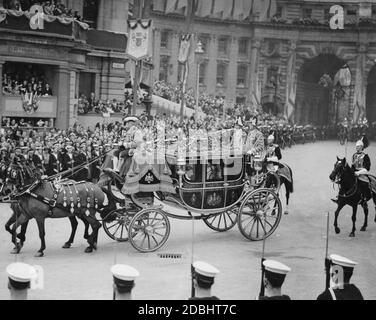 The carriage in which Viscount Lascelles, the King's page of honour and nephew, Princess Elizabeth (right) and Princess Margaret Rose, drive through Trafalgar Square towards Westminster Abbey for the coronation celebrations in honour of King George VI. Stock Photo