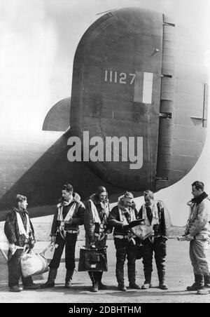 'The US crew of the ''Liberator'' checks the flight logbook after landing.' Stock Photo