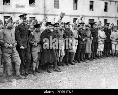 British and French soldiers arm in arm in Calais before marching off to the Saar region to reinforce the International Protection Force there. Stock Photo