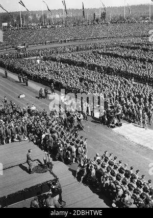 Adolf Hitler gives a speech at the Municipal Stadium in Nuremberg at the rally of the Hitler Youth during the Nazi Party Congress. The event is filmed by several camera teams and photographers. Stock Photo