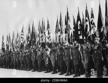 Numerous standard-bearers of the SA and other Nazi organisations march in the Luitpoldarena on the Nuremberg Reich Party Rally Grounds. Stock Photo