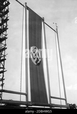 During the preparations for the Nazi Party Congress in Nuremberg, a swastika flag is hoisted above the platform in the Luitpold Arena. Stock Photo