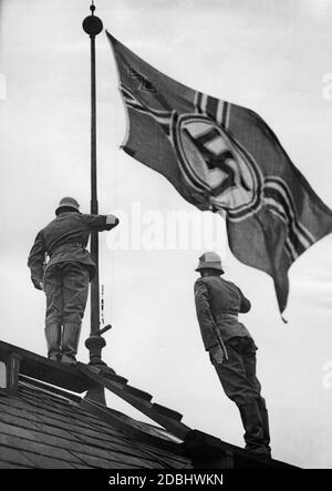 On the occasion of Adolf Hitler's speech in Essen, the Reichskriegsflagge (Imperial War Flag) is raised on the roofs of the barracks in Rathenowersstrasse in Berlin. The speech is an electoral speech for the Reichstag elections. Stock Photo